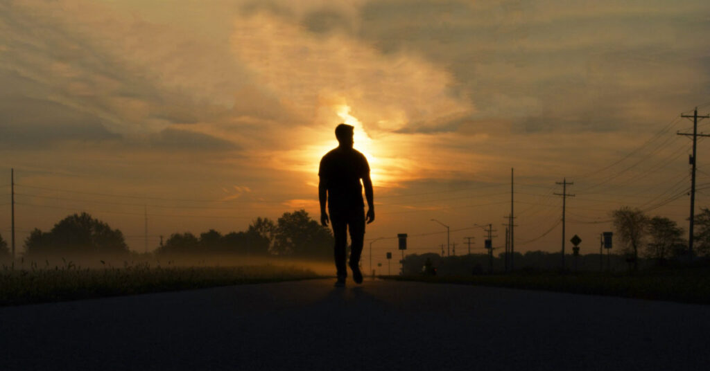 Person walking in the morning for better energy and good vibes